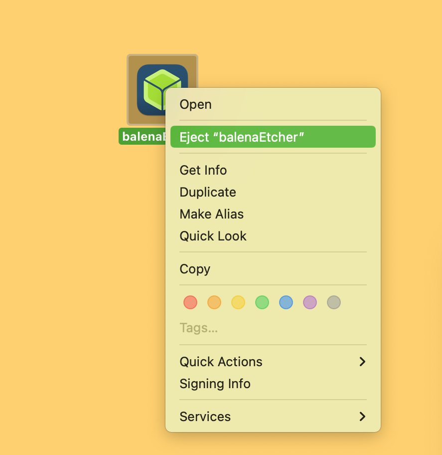 Screenshot of a desktop showing the balenaEtcher installation icon and a macOS menu with the option to Eject balenaEtcher.